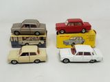 three toy cars are sitting on a white surface next to a box