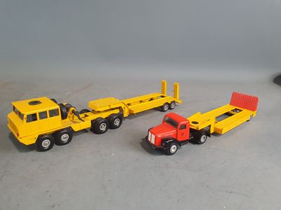 three toy trucks that are sitting next to each other