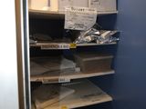 a closet with a lot of boxes and papers on the shelves