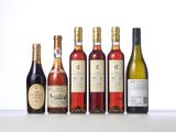 four bottles of wine are lined up on a table