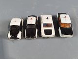 several toy cars are lined up in a row on a gray surface