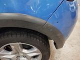 a close up of a blue car with a flat tire