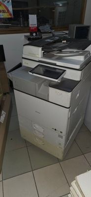 a stack of papers sitting on top of a printer
