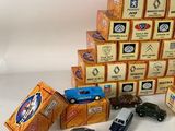 several toy cars are stacked on top of each other on a white surface