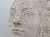sculpture of a woman ' s head with a rope around her neck
