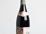 the bottle of wine is sitting on the table with sprinkles on it