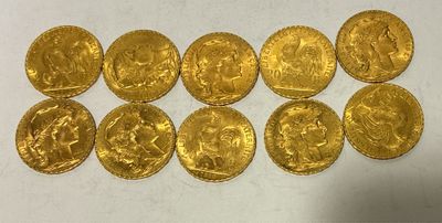 a bunch of gold coins sitting on top of a white surface