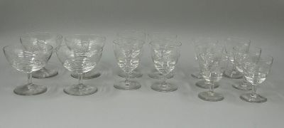 six wine glasses are lined up on a white surface