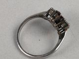 a close up of a silver ring on a white surface