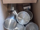 a cardboard box with a bunch of tins inside of it