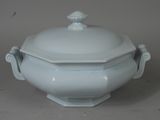 a white bowl with a lid on a table