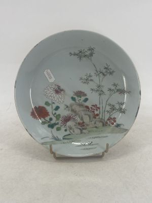 a plate with a picture of a cat and flowers on it