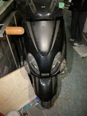 a motor scooter that is parked in a garage