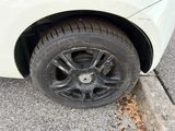 a white car that has a flat tire on the street
