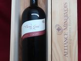 a bottle of wine in a wooden box on a red cloth