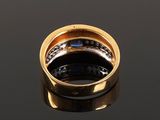 a close up of a gold ring on a black surface