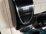 a paper towel dispenser on the wall above a toilet