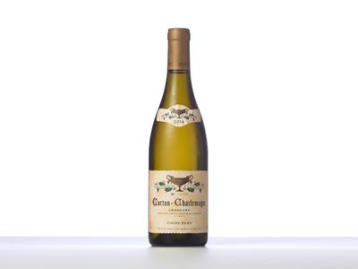 a bottle of white wine sitting on top of a table