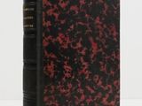 a black and red book sitting on top of a white table