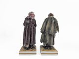 two figurines of a man and a woman dressed in robes