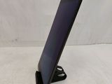 a tablet that is sitting on a stand on a table