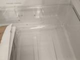 an empty refrigerator with the door open and no food in it