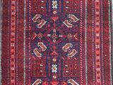 a red and blue rug with a pattern on it