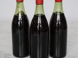 three bottles of wine sitting on top of a marble counter top