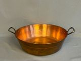 an old copper pan with handles and handles on a white background