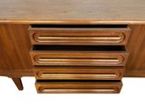 a close up of a wooden cabinet with four drawers
