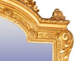 a mirror with a gold frame on a white background