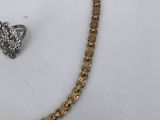 an image of a gold chain with a heart shaped pendant