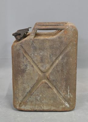 an old metal canister with a metal handle on a white surface