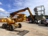 a yellow crane that is sitting in a parking lot