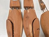 several wooden shoes are lined up on a white surface