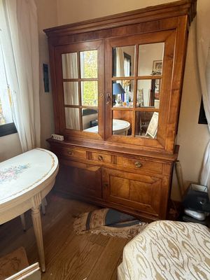 a dresser and a table in a room with a window