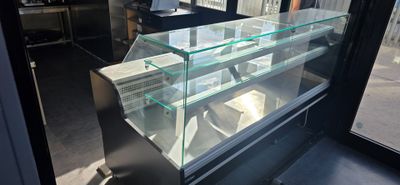 a glass display case in the middle of a store