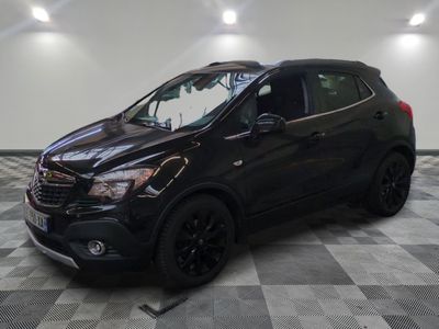 a black buick suv is parked in a garage
