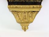 a black and gold clock on a gold stand