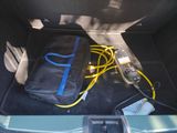 a bag and a cord in the trunk of a car
