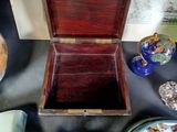a small wooden box with a lid on a table