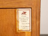 a sign on the door of a cabinet that has a picture of a fox on it
