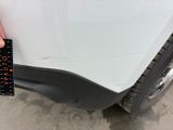 someone is measuring the width of the front bumper of a car