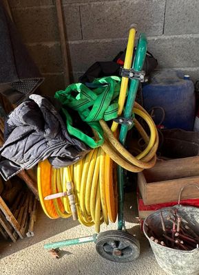 a pile of hoses and other items in a garage