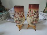 two vases that are sitting on a table