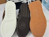 three pairs of shoes are shown in front of a box