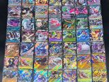 a large collection of pokemon cards sitting on top of a table