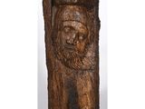 a wooden carving of a bearded man with a beard