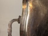 a silver tray with a handle on it on a table