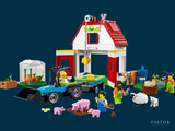 a toy farm with animals and farm animals in front of it